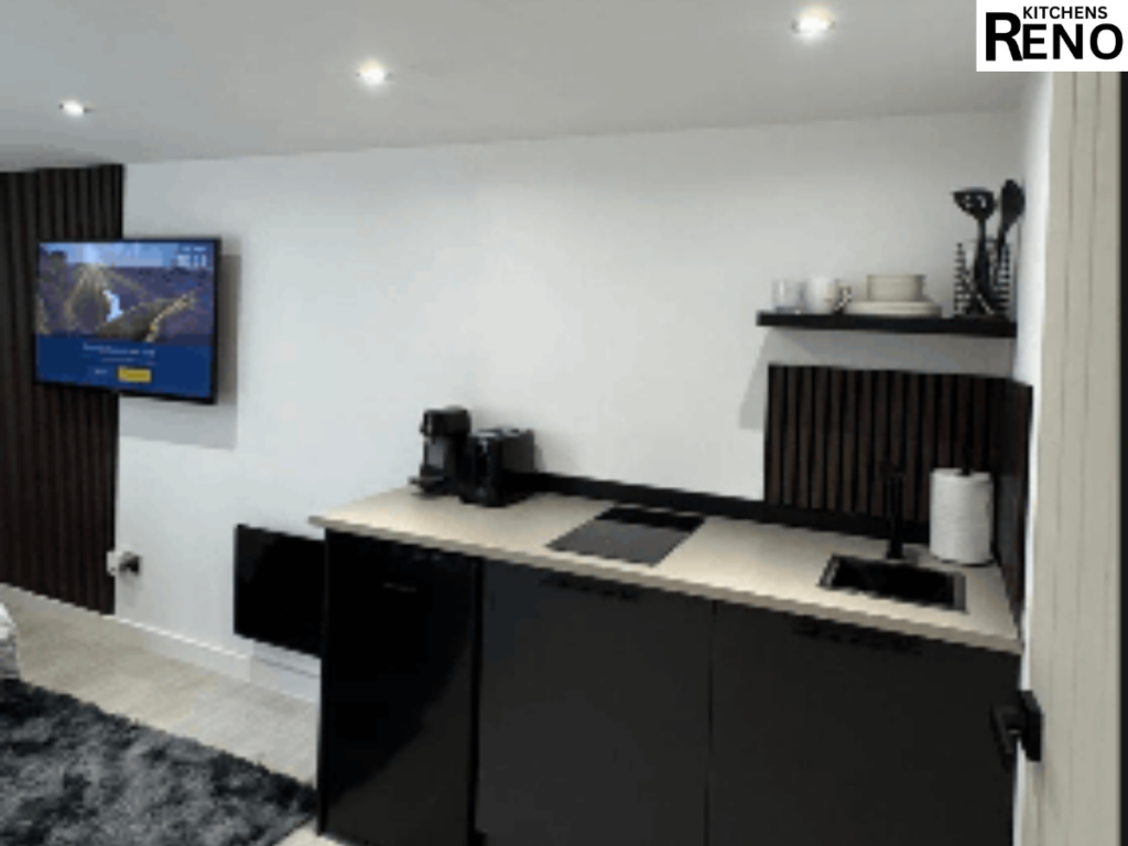 Modern black and white kitchen installation in Toxteth with sleek cabinets, worktops, sink, and wall shelving.
